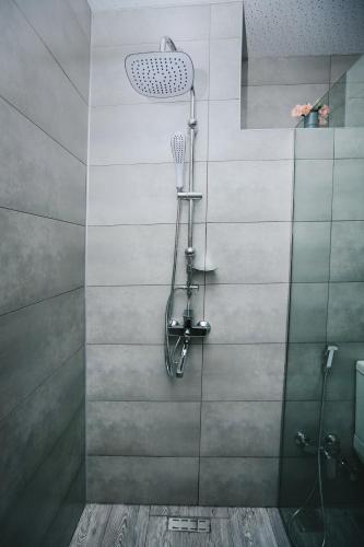 a bathroom with a shower with a glass door at Hotel Tamar Mepe in Kutaisi