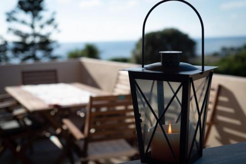 a black lantern sitting on a table with a candle at Naiada Stomio-A apartment in Filiatra
