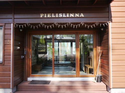 a entrance to a building with a glass door at PielisLinna in Kolinkylä