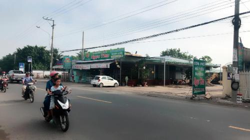 a group of people riding motorcycles down a street at Ngoc Kha Tu 2 Hotel in Long Xuyên