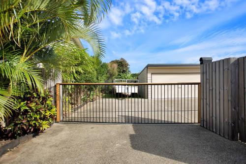 a gate to a house with a garage at North Central Holiday Home in North Mackay