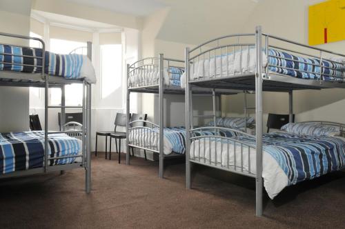 a group of bunk beds in a room at The Hostel in Edinburgh