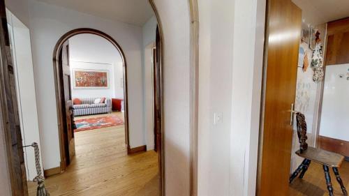 a hallway with a mirror and a living room at Caspar Badrutt - St. Moritz in St. Moritz