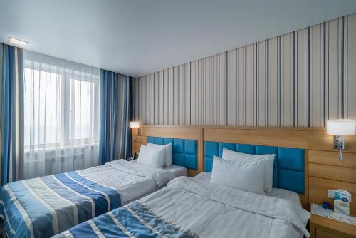 Кровать или кровати в номере Экватор Конгресс-отель 