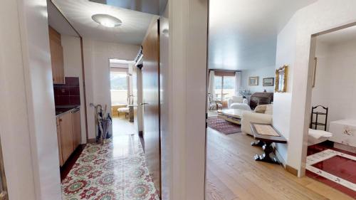 a kitchen and living room with a view of a living room at Caspar Badrutt - St. Moritz in St. Moritz