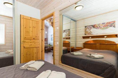 A bed or beds in a room at OtsoPirtti: Maria and Otso Apartments
