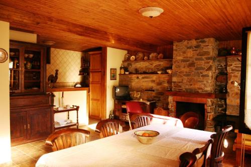 a dining room with a table and a fireplace at Ninho do Melro - Turismo Rural Bragança in Bragança