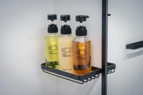 a shelf with three bottles of liquids in a refrigerator at hotel androoms Nagoya Fushimi in Nagoya