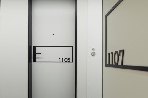 an open door with the number and theorems at hotel androoms Nagoya Fushimi in Nagoya