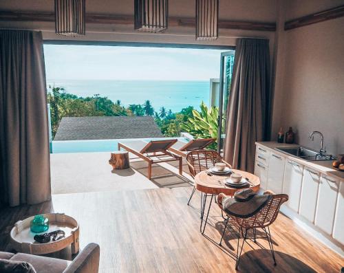a kitchen and living room with a view of the ocean at Mayara pool villas - Adults only in Haad Yao