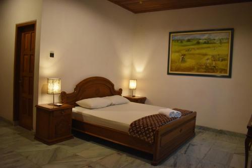 A bed or beds in a room at D Ajenk Boutique Villa