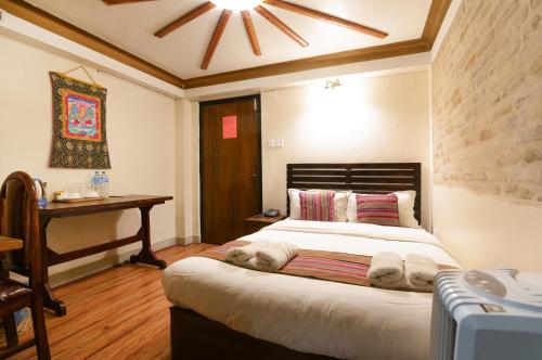 a bedroom with a bed with towels on it at Nepal Pavilion Inn in Kathmandu