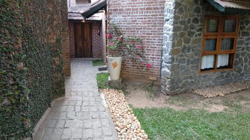 a brick building with a plant in a pot next to a door at Wildernest in Thekkady