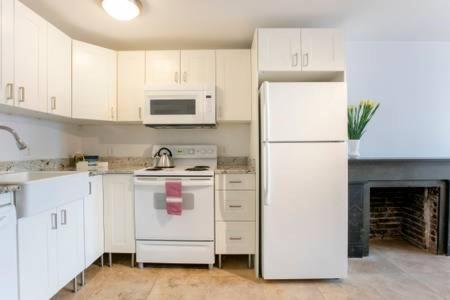 a kitchen with white appliances and a white refrigerator at Big Bright 1 BR at U/Shaw + 14th on Quaint Swann in Washington