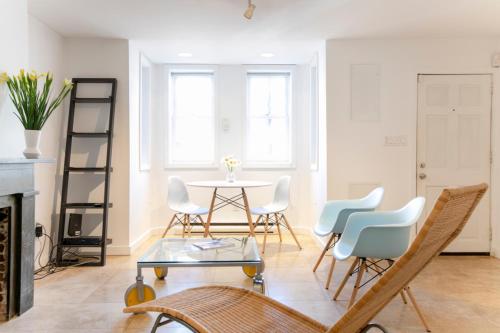 a living room with a table and chairs at Big Bright 1 BR at U/Shaw + 14th on Quaint Swann in Washington