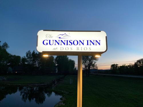 a sign for a gunion inn at dogs hops at The Gunnison Inn at Dos Rios Golf Course in Gunnison