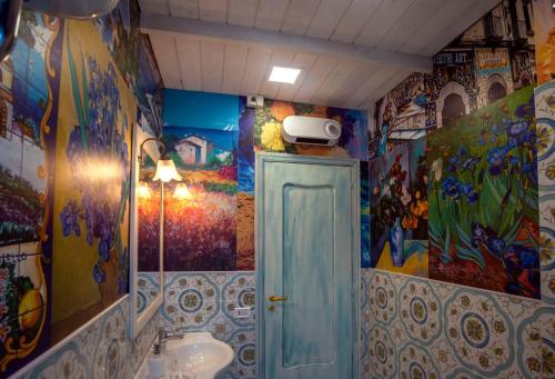 a bathroom with colorful walls and a sink and a bathroomarijavascript at Nives Bed & Breakfast in Pompei