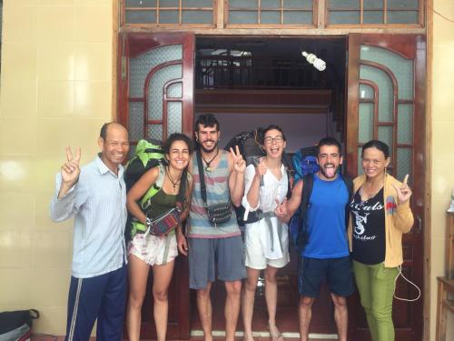a group of people standing in front of a door at Hiep Tung homestay in Tân Hiệp