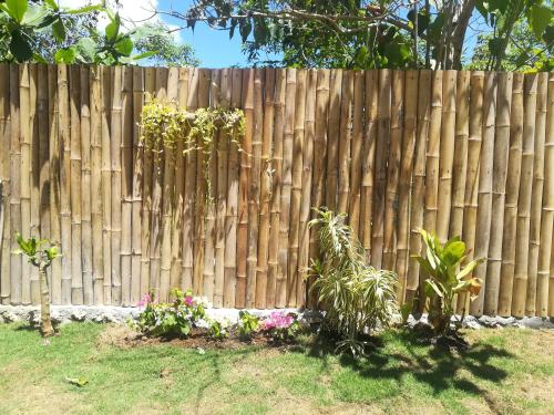 a wooden fence with some plants in front of it at Christelle Inn in Panglao