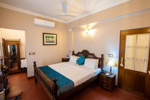 a bedroom with a large bed in a room at 19VillaMira in Puducherry