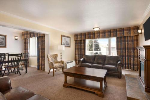a living room with a couch and a table at Ramada by Wyndham Spokane Airport in Spokane