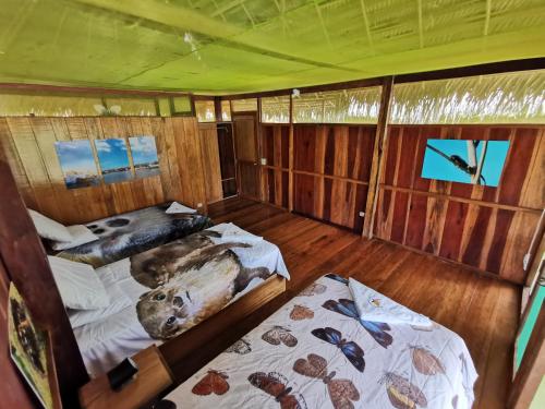 an inside view of a boat with two beds at Grand Amazon Lodge and Tours - All Inclusive in Paraíso