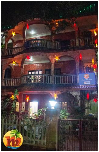 a large building with stars on it at night at Mama Mids Home in Morjim