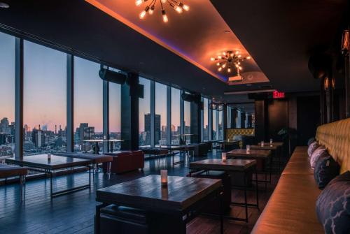 a restaurant with tables and a view of the city at Wyndham Garden Chinatown in New York