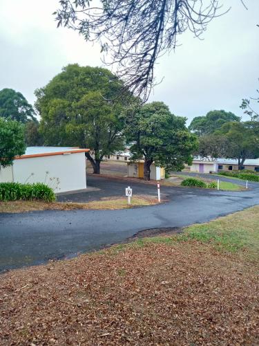 an empty road with trees in the background at Limestone Coast Tourist Park in Mount Gambier
