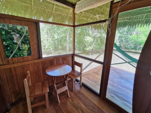 a room with a table and chairs in a tree house at Grand Amazon Lodge and Tours - All Inclusive in Paraíso