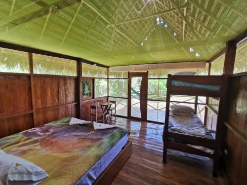 a bedroom with a bed and a chair in a room at Grand Amazon Lodge and Tours - All Inclusive in Paraíso