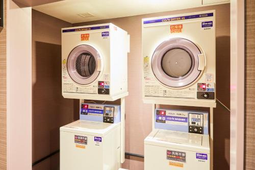 three washing machines on display in a room at Hotel Wing International Kobe - Shinnagata Ekimae in Kobe