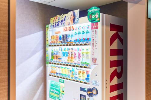 a refrigerator with a drink dispenser in a room at Hotel Wing International Kobe - Shinnagata Ekimae in Kobe