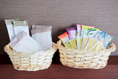 two baskets sitting on a table with pamphlets at Hotel Wing International Kobe - Shinnagata Ekimae in Kobe