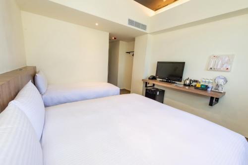 Postel nebo postele na pokoji v ubytování Traveller Inn Tiehua Cultural and Creative Hotel II