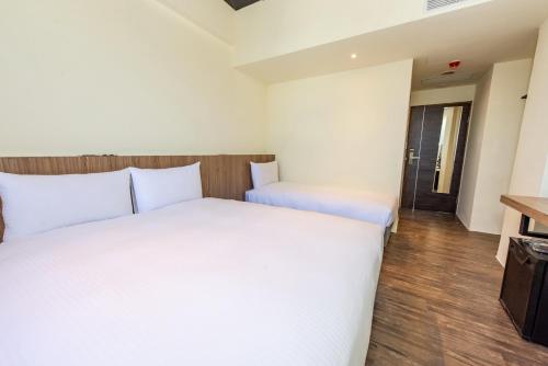 Postel nebo postele na pokoji v ubytování Traveller Inn Tiehua Cultural and Creative Hotel II