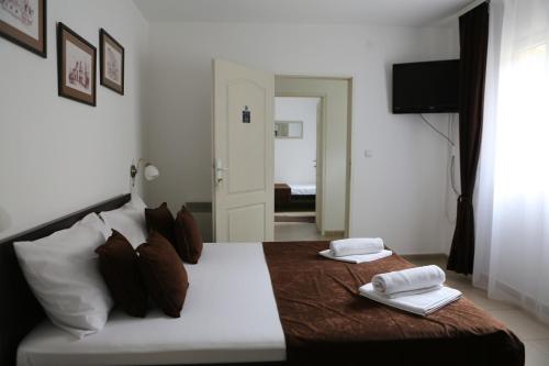 a bedroom with a bed with two towels on it at Apartments & Dream Rooms in Niš