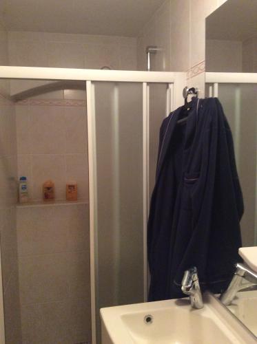 a bathroom with a sink and a towel hanging on a rack at CHAMBRE INDEPENDANTE + SANITAIRE près centre ville in Rignac - Aveyron