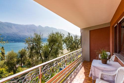 a balcony with a table and a view of the water at Hotel Riviera Panoramic Green Resort in Limone sul Garda