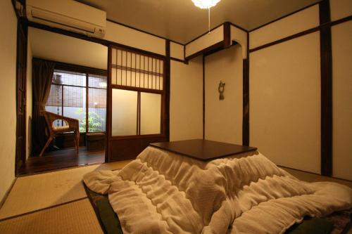 a room with a bed in the corner of a room at HARUYA Umekoji in Kyoto
