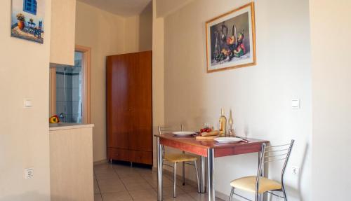 a kitchen with a table and chairs in a room at Hotel Loukas Vrachos in Paralia Vrachou