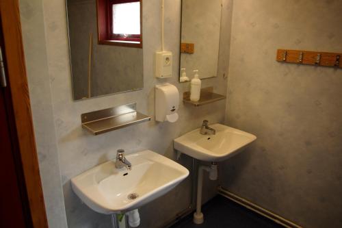 a bathroom with two sinks and a mirror at Halens Camping och Stugby in Olofström