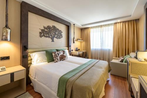 a hotel room with a large bed and a couch at Santemar in Santander