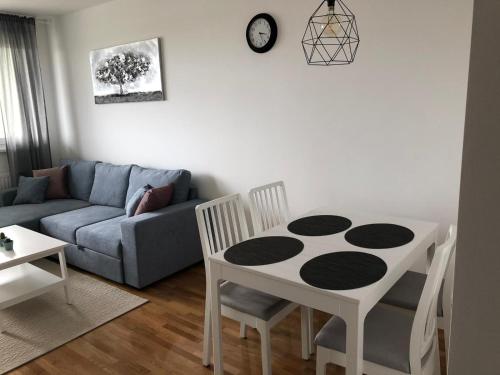 a living room with a table and a couch at Apartman STAR in Zagreb