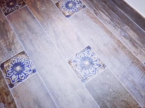 an overhead view of a floor with blue and white tiles at L' Arena Suite - Sicilian style 140 mq flat with balcony and Arena seeview in Castellammare del Golfo