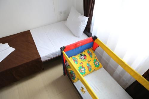 a small bed with a chair in a room at Apartments & Dream Rooms in Niš