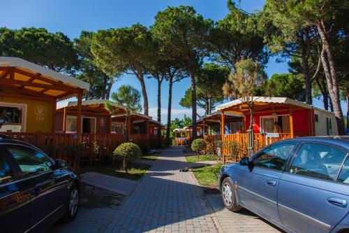 a car parked in front of a row of houses at Camping Village Cavallino in Cavallino-Treporti