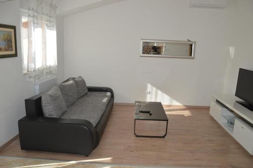 a living room with a couch and a coffee table at Apartments Babic in Podstrana