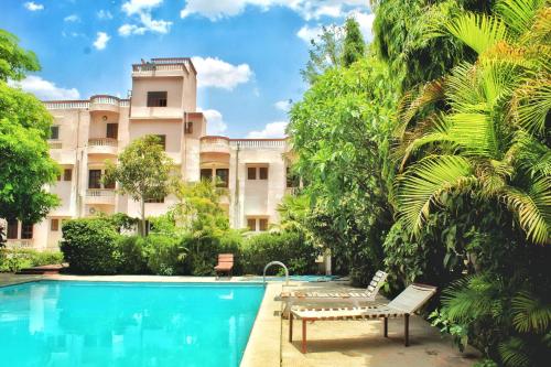 un hôtel avec une piscine en face d'un bâtiment dans l'établissement Green Park Resort, à Pushkar