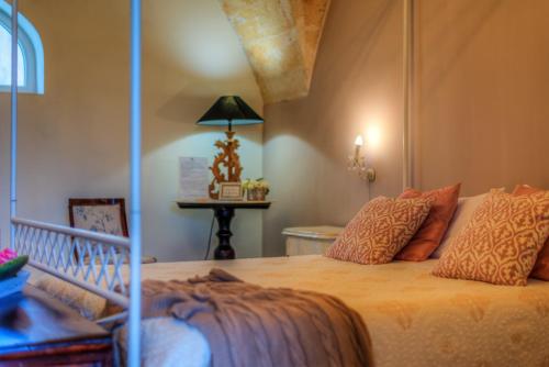 a bedroom with a bed and a table with a lamp at Masseria Sorani in Manduria